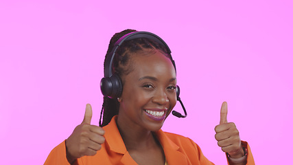 Image showing Business woman, call center and thumbs up for communication, happy sales and customer service on pink background. Portrait of African consultant or agent, yes and like emoji for contact us in studio