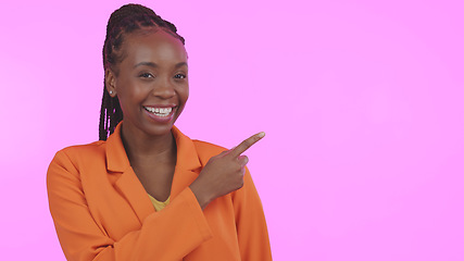 Image showing Black woman, smile and pointing for advertising in studio on blank mock up space for presentation. Portrait, happy or person with promotion for business, marketing or offer on pink background