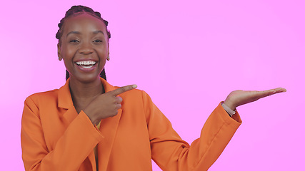 Image showing Black woman, pointing and advertising in studio on empty hand, palm or mock up space. Portrait, happy or person with promotion for business, marketing or offer and presentation on pink background
