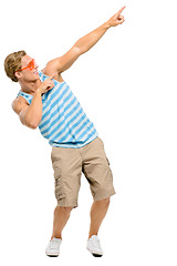 Image showing Lets get this summer going in full swing. Full length shot of a handsome young man standing alone in the studio and pointing at a promotion.