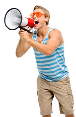 Image showing Is this loud enough for everyone. a handsome young man standing alone in the studio and using a megaphone.