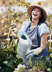 Image showing Dandelions are the genies of the plant world. a young female florist watering plants at work.