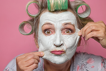 Image showing funny senior women with clay face mask