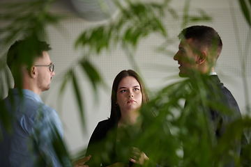 Image showing A diverse group of business professionals gathered at a modern office for a productive and inclusive meeting