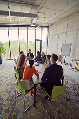 Image showing A diverse group of business professionals gathered at a modern office for a productive and inclusive meeting