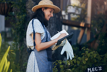 Image showing Plant a garden. a young female florist working at a nursery.