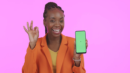 Image showing Business woman, phone green screen and okay for website information, marketing space and success on pink background. Portrait of African person with mobile mockup and yes emoji for contact in studio