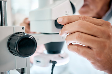 Image showing Look closely, theres a lot to see. Closeup shot of an unrecognisable scientist using a microscope in a lab.