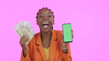 Image showing Woman, phone green screen and money for success, bonus or winning of lottery or competition, profit and wow in studio. African winner, portrait and mobile mockup for cash prize on a pink background