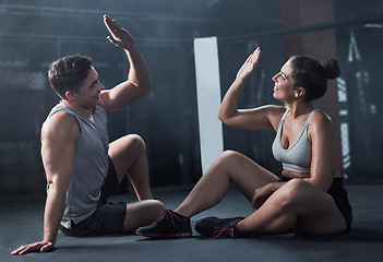 Image showing Give it your best and get what youve always wanted. a young man and woman giving each other a high five at the gym.