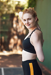 Image showing Warming up my game. Cropped portrait of an attractive young female athlete stretching while standing on the basketball court.