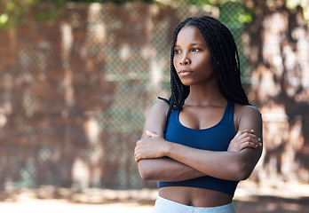 Image showing The court brings out her confidence. an attractive young female athlete standing with her arms folded on the basketball court.