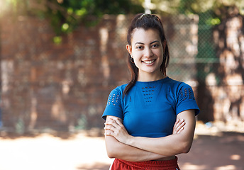 Image showing This game gives me confidence. Cropped portrait of an attractive young female athlete standing with her arms folded on the basketball court.