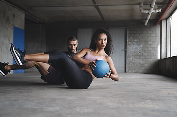 Image showing Keep the intensity on a high level. Full length shot of a sport young couple exercising with a ball inside a parking lot.