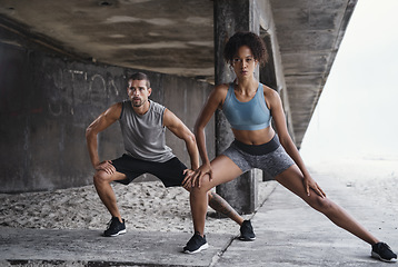Image showing Every stretch matters in the long run. Full length shot of a sporty young couple exercising together outdoors.
