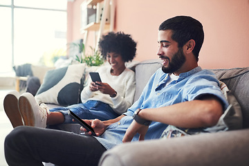 Image showing When were bored, we turn to the internet for entertainment. a couple using their cellphones while relaxing at home.