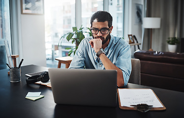 Image showing I know just where to go for inspiration. a young man using his laptop while working from home.