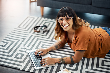 Image showing Im writing another post for my blog. a young woman using her laptop while relaxing at home.