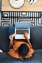 Image showing Youll always find good deals online. High angle shot of a young woman holding a credit card while using her laptop.