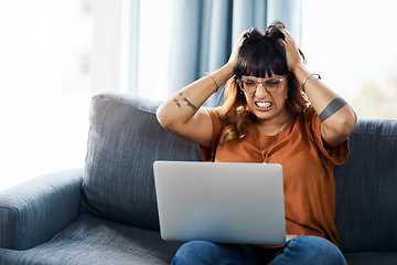 Image showing Whats wrong with it. a woman looking frustrated while using her laptop at home.