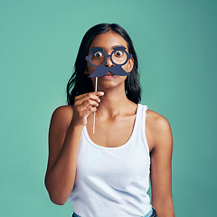 Image showing No one will recognise me now. Studio portrait of a beautiful young woman posing with prop glasses against a green background.