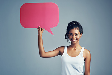 Image showing Have your say. Studio portrait of a beautiful young woman holding up a blank signboard against a grey background.