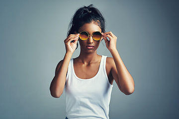 Image showing Feeling cool. Studio portrait of a beautiful young woman posing against a grey background.