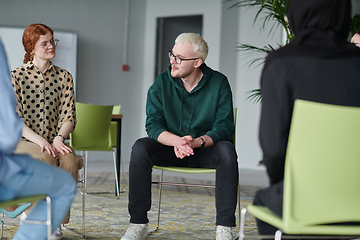 Image showing A young businessman passionately sharing his business ideas with his colleagues, fostering an atmosphere of collaboration and innovation in a dynamic and engaging workplace