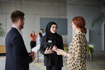 Image showing A group of young business entrepreneurs engages in a lively discussion within the office, exemplifying the spirit of teamwork, innovation, and ambition in pursuit of success.