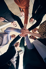 Image showing A group of businessmen holding hands together to symbolize unity and strength