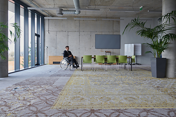 Image showing Businessman in a wheelchair in a modern office lonely after a busy day