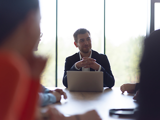 Image showing A diverse group of business professionals gathered at a modern office for a productive and inclusive meeting