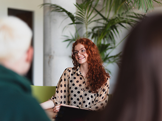 Image showing A diverse group of business professionals gathered at a modern office for a productive and inclusive meeting