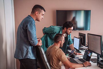 Image showing Programmers engrossed in deep collaboration, diligently working together to solve complex problems and develop innovative mobile applications with seamless functionality.