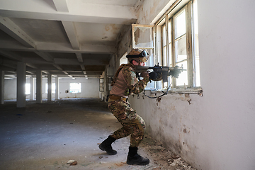 Image showing A professional soldier carries out a dangerous military mission in an abandoned building