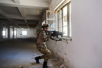 Image showing A professional soldier carries out a dangerous military mission in an abandoned building