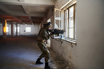 Image showing A professional soldier carries out a dangerous military mission in an abandoned building