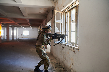 Image showing A professional soldier carries out a dangerous military mission in an abandoned building