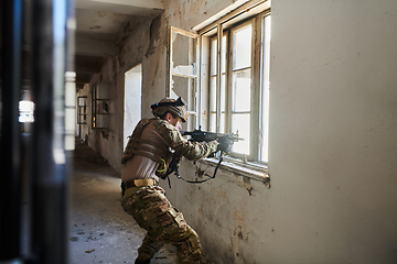 Image showing A professional soldier carries out a dangerous military mission in an abandoned building