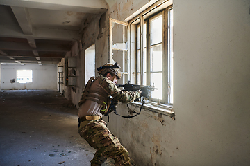 Image showing A professional soldier carries out a dangerous military mission in an abandoned building