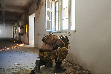 Image showing A professional soldier carries out a dangerous military mission in an abandoned building