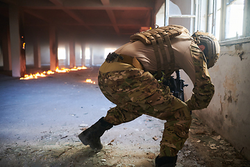 Image showing A professional soldier carries out a dangerous military mission in an abandoned building