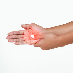 Image showing Where did this come from. Studio shot of an unrecognizable woman holding her hand in pain against a white background.