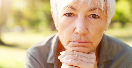 Image showing Experience teaches best. Closeup portrait of a senior woman contemplating with her hands clasped outdoors.