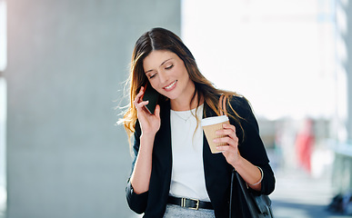 Image showing Business is about calling the right people. an attractive young businesswoman taking a a phonecall while walking through a modern office.