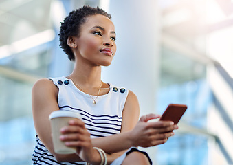 Image showing Business mindedness Activated. an attractive young businesswoman looking thoughtful while using a smartphone in a modern office.