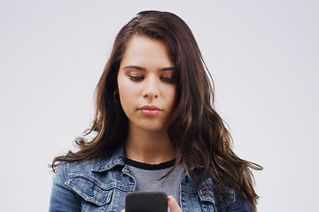 Image showing Bored Jump online. a young woman reading something on her cellphone.