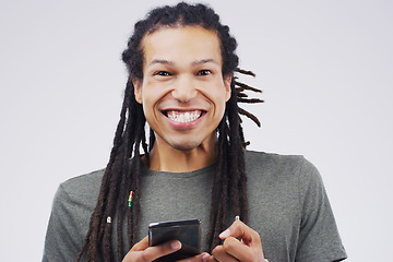 Image showing The cyber world gives us the confidence to get the girl. Studio shot of a happy young man using his cellphone.