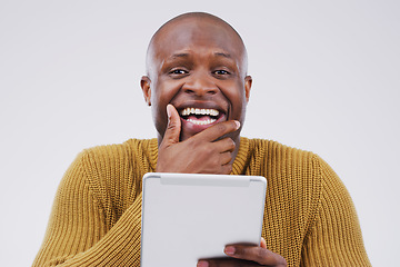 Image showing Seems like the internet has something for everyone. Studio shot of a young man looking surprised while using a digital tablet.