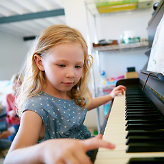 Image showing Shes about to become the next musical prodigy. a little girl playing the piano.